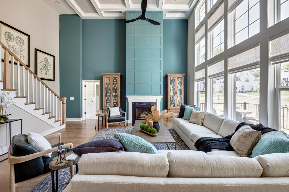 Inspiration pour un salon traditionnel avec un mur bleu, un sol en bois brun, une cheminée standard, un sol marron et un plafond à caissons.