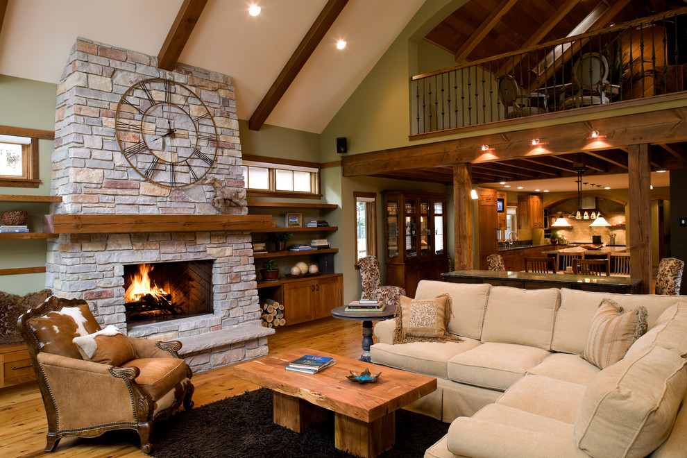 Inspiration for a traditional family room in Minneapolis with green walls and a stone fireplace surround.