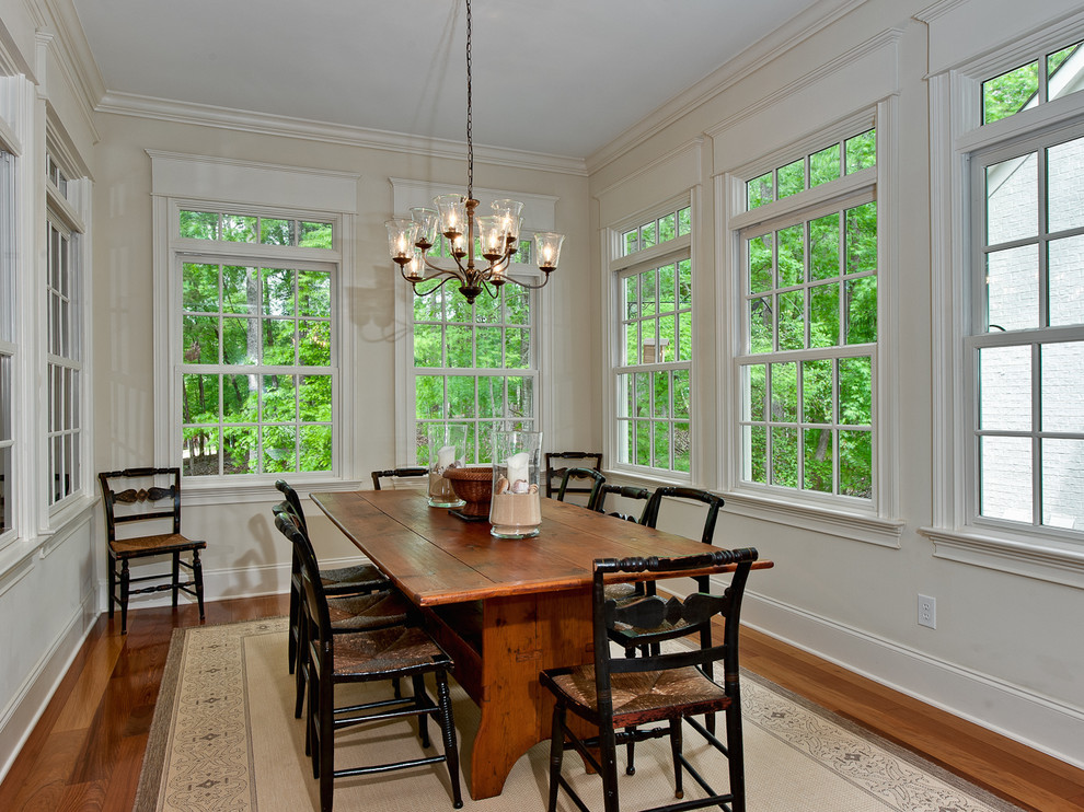 Inspiration for a traditional separate dining room in Charlotte with white walls and medium hardwood floors.