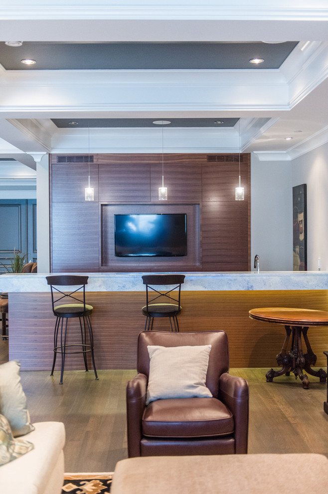 This is an example of a large transitional home bar in Vancouver.