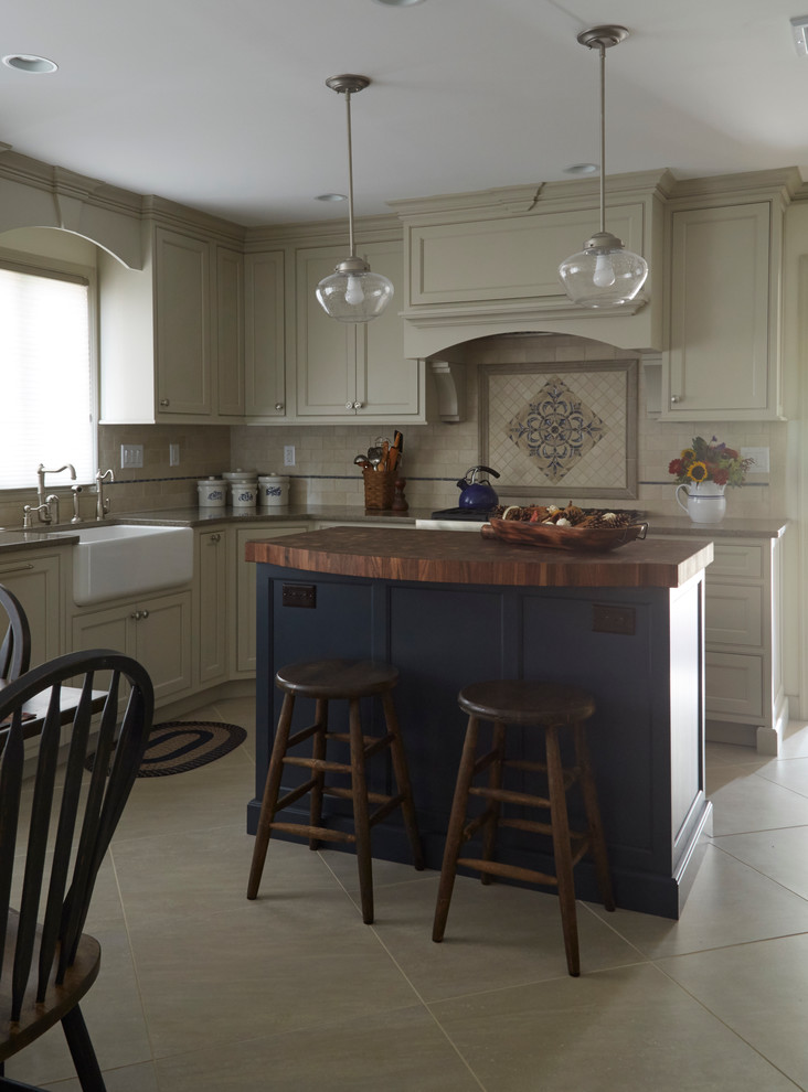 Eat-in kitchen - mid-sized transitional u-shaped ceramic tile and beige floor eat-in kitchen idea in Philadelphia with a farmhouse sink, beaded inset cabinets, beige cabinets, beige backsplash, ceramic backsplash, stainless steel appliances and an island