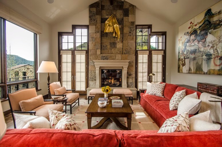 This is an example of an expansive traditional open concept living room in Denver with a stone fireplace surround.