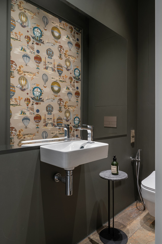 Esempio di un piccolo bagno di servizio eclettico con WC sospeso, pareti verdi, pavimento in gres porcellanato, lavabo sospeso, pavimento marrone e carta da parati