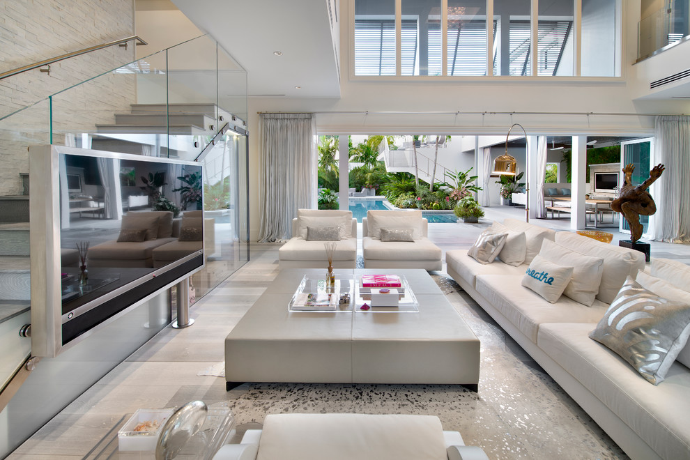 Expansive contemporary open concept living room in Miami with white walls and medium hardwood floors.