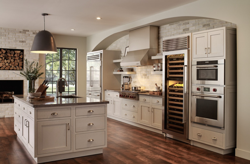 Design ideas for a large galley eat-in kitchen in Charleston with a single-bowl sink, shaker cabinets, distressed cabinets, granite benchtops, multi-coloured splashback, stone tile splashback, stainless steel appliances, marble floors, with island, brown floor and brown benchtop.