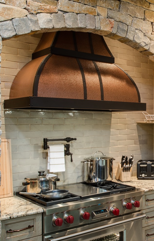 Concrete floor eat-in kitchen photo with a farmhouse sink, granite countertops, white backsplash, subway tile backsplash, stainless steel appliances, recessed-panel cabinets, light wood cabinets and an island