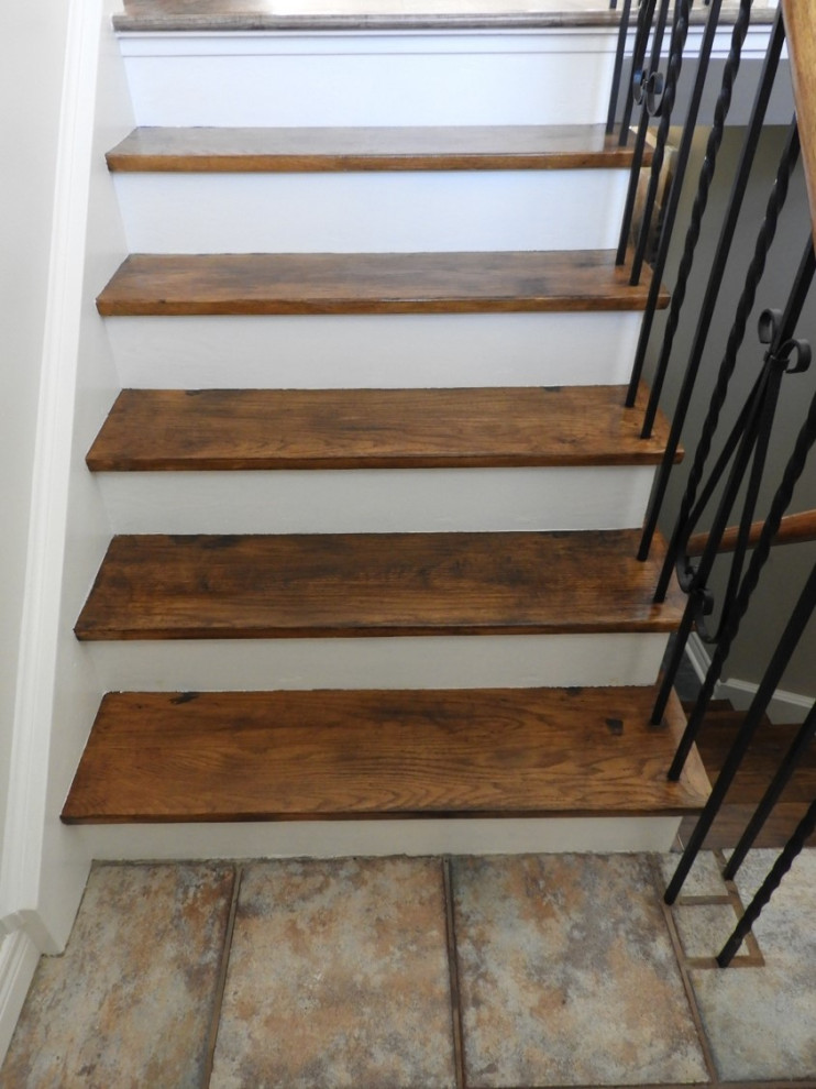 Inspiration for a small contemporary wood u-shaped staircase in Toronto with painted wood risers and metal railing.