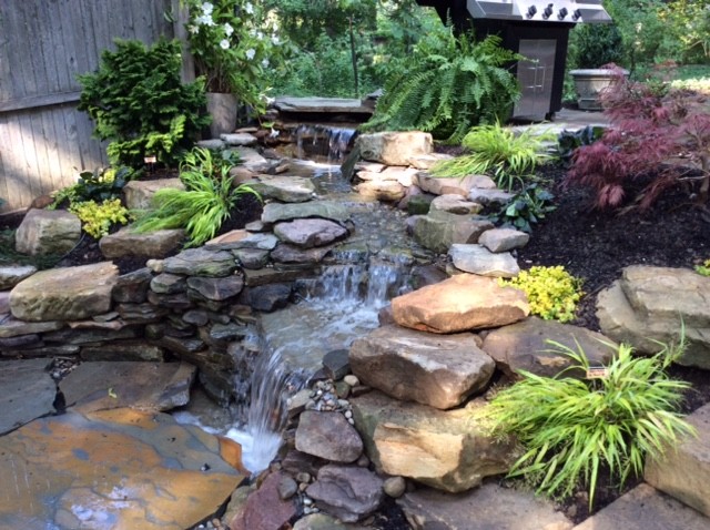 Inspiration for a traditional backyard garden in Cleveland with a water feature.