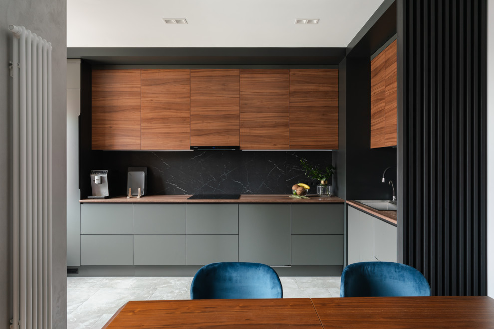 Inspiration for a mid-sized contemporary l-shaped eat-in kitchen in Saint Petersburg with a double-bowl sink, flat-panel cabinets, grey cabinets, wood benchtops, black splashback, porcelain splashback, panelled appliances, porcelain floors, grey floor and brown benchtop.