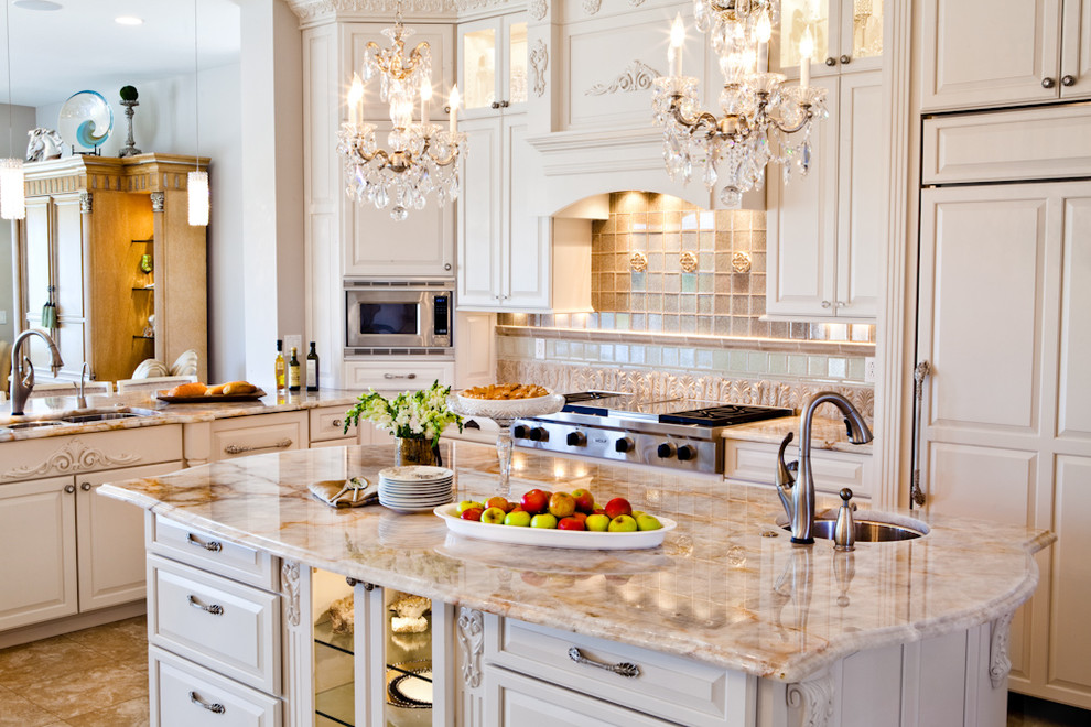 Design ideas for a large traditional u-shaped eat-in kitchen in St Louis with a triple-bowl sink, raised-panel cabinets, white cabinets, granite benchtops, beige splashback, stone tile splashback, panelled appliances, travertine floors and with island.