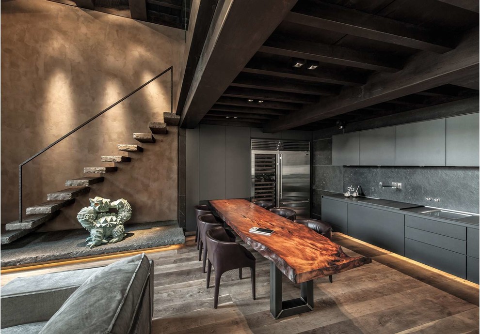 Inspiration for a contemporary l-shaped open plan kitchen in Milan with an undermount sink, flat-panel cabinets, grey cabinets, stainless steel appliances, dark hardwood floors, no island, brown floor and grey benchtop.