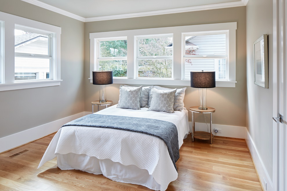 Design ideas for a mid-sized transitional guest bedroom in Portland with grey walls and light hardwood floors.