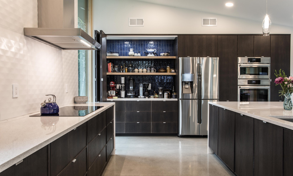 Example of a trendy l-shaped concrete floor and gray floor kitchen design in Portland with an undermount sink, flat-panel cabinets, medium tone wood cabinets, an island and gray countertops