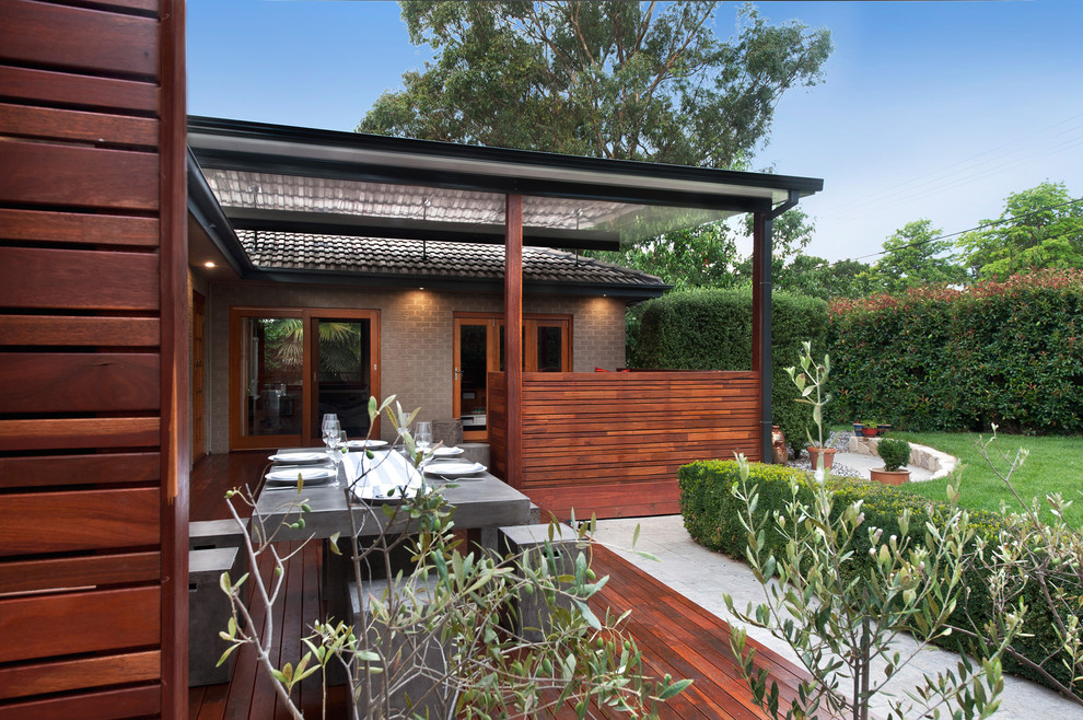 This is an example of a small contemporary backyard deck in Canberra - Queanbeyan with a roof extension.