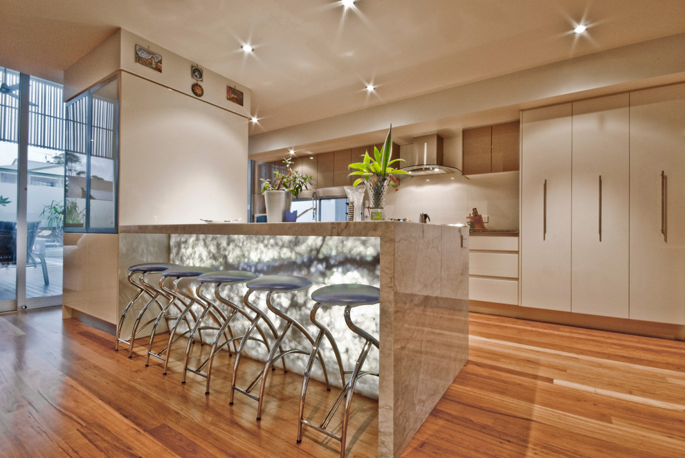 Modern kitchen in Sunshine Coast with flat-panel cabinets and with island.