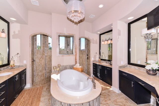 Photo of a large contemporary ensuite bathroom in Austin with shaker cabinets, black cabinets, a built-in bath, an alcove shower, a two-piece toilet, beige tiles, brown tiles, porcelain tiles, beige walls, travertine flooring, a submerged sink, marble worktops, beige floors and a hinged door.