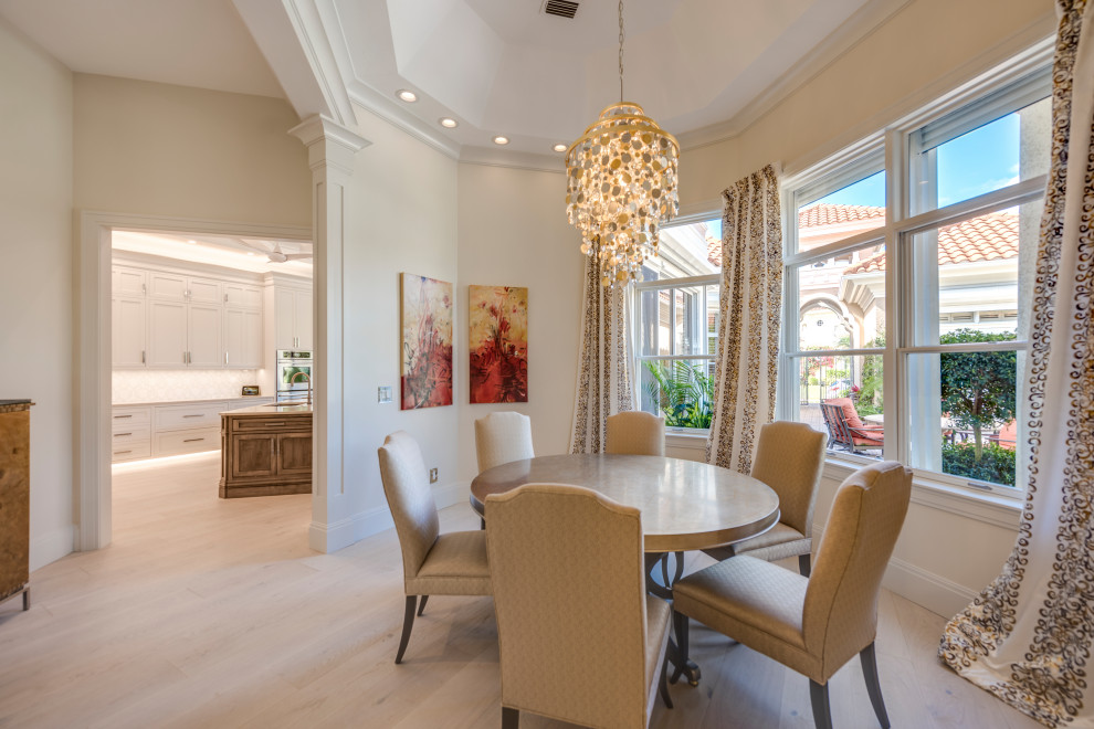 Transitional light wood floor, beige floor and vaulted ceiling great room photo with beige walls and no fireplace