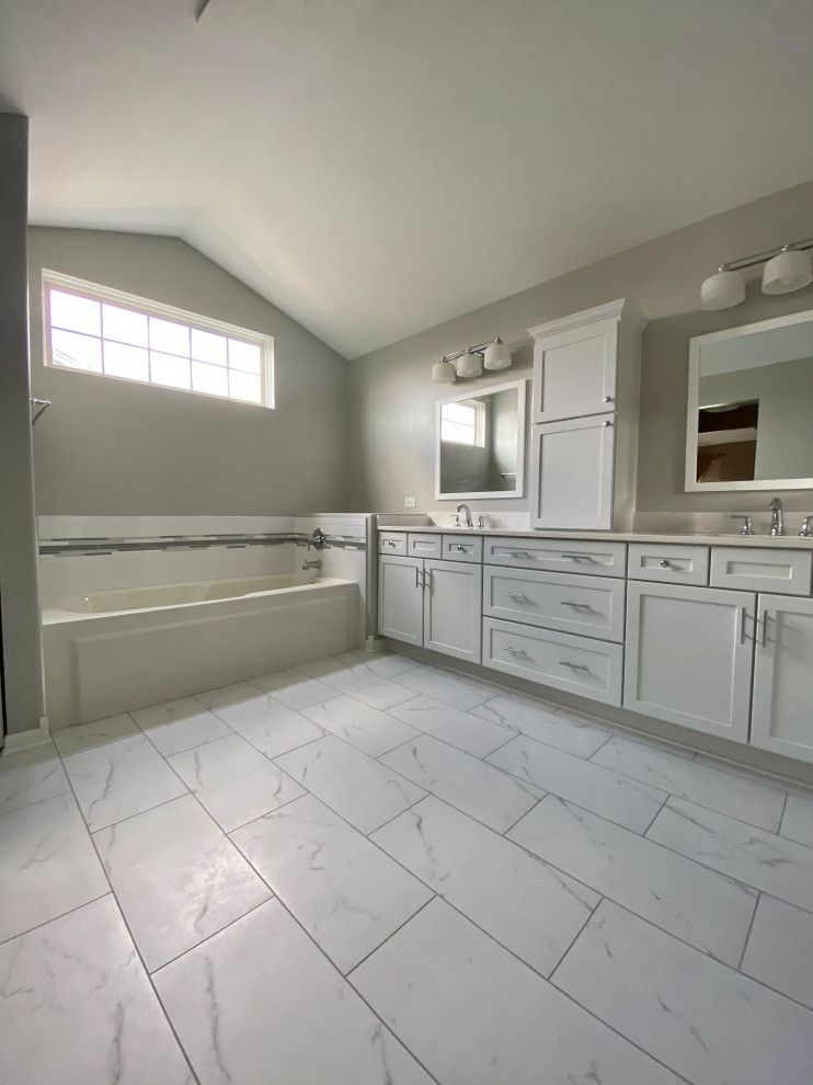 Inspiration for a mid-sized modern master bathroom in Chicago with shaker cabinets, white cabinets, an alcove tub, white tile, subway tile, grey walls, an undermount sink, quartzite benchtops, white floor, white benchtops, a double vanity and a built-in vanity.