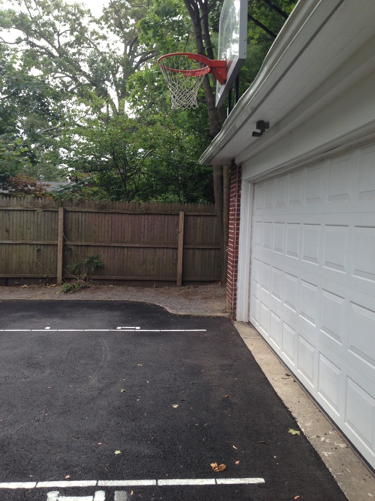 Photo of a mid-sized traditional side yard partial sun outdoor sport court in New York with concrete pavers.
