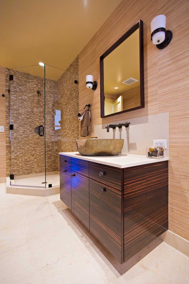 Mid-sized eclectic 3/4 bathroom in San Francisco with a vessel sink, flat-panel cabinets, dark wood cabinets, limestone benchtops, a corner shower, a one-piece toilet, beige tile, stone tile, brown walls and limestone floors.