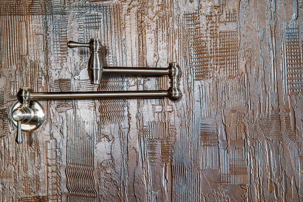 Kitchen - traditional kitchen idea in Phoenix with metallic backsplash, stainless steel appliances and an island