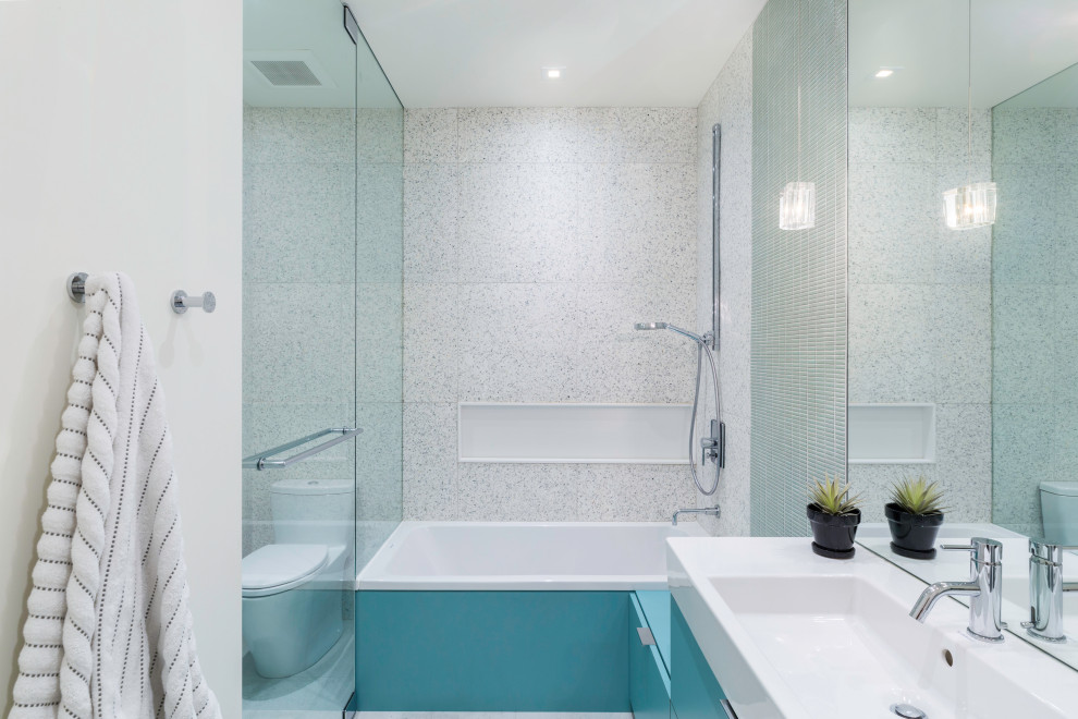 Bathroom - contemporary kids' beige tile and ceramic tile ceramic tile, white floor and single-sink bathroom idea in New York with flat-panel cabinets, turquoise cabinets, a two-piece toilet, white walls, an integrated sink, solid surface countertops, a hinged shower door, white countertops and a floating vanity