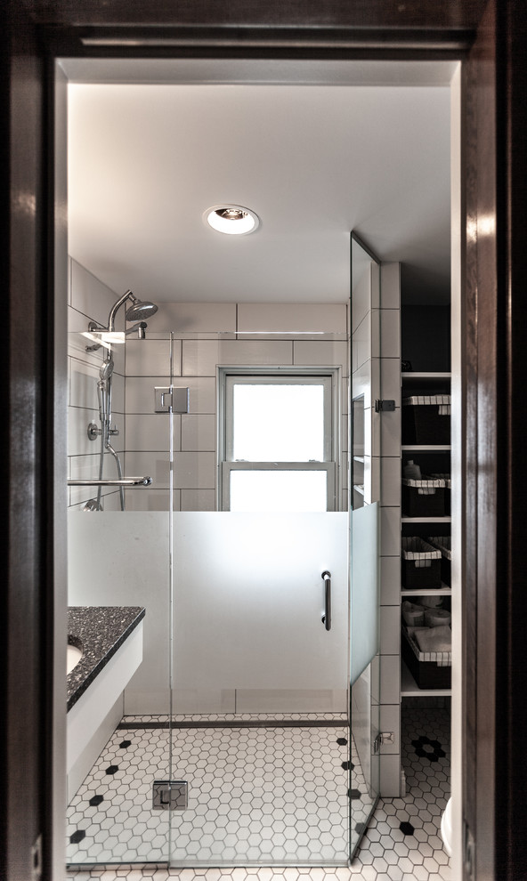 Photo of a small traditional 3/4 bathroom in Minneapolis with a curbless shower, a wall-mount toilet, white tile, ceramic tile, blue walls, porcelain floors, an undermount sink, recycled glass benchtops, white floor, a hinged shower door and grey benchtops.
