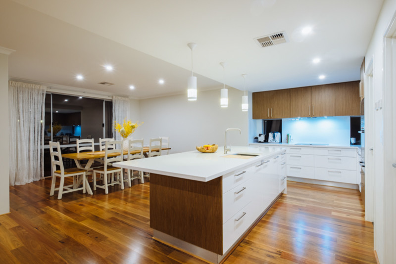 This is an example of a mid-sized contemporary galley eat-in kitchen in Perth with recessed-panel cabinets and with island.