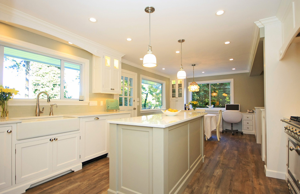 Inspiration for a mid-sized contemporary l-shaped eat-in kitchen in Vancouver with a farmhouse sink, white cabinets, quartz benchtops, medium hardwood floors and with island.