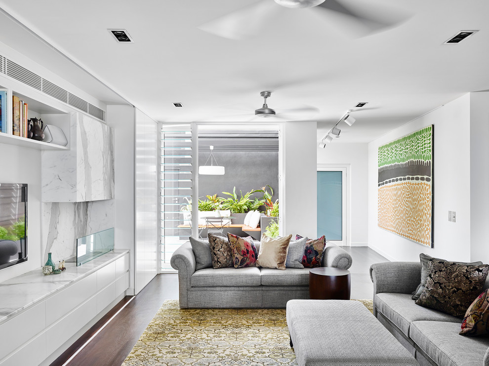 Photo of a contemporary open concept living room in Brisbane with white walls and a wall-mounted tv.