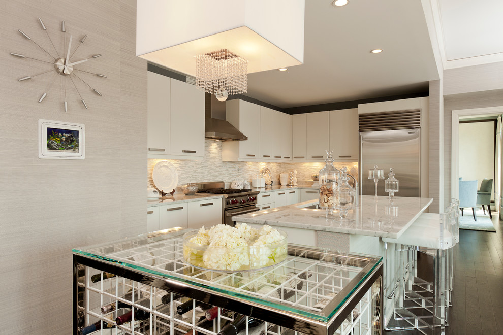 This is an example of a contemporary l-shaped kitchen in Chicago with an undermount sink, flat-panel cabinets, white cabinets, multi-coloured splashback and stainless steel appliances.