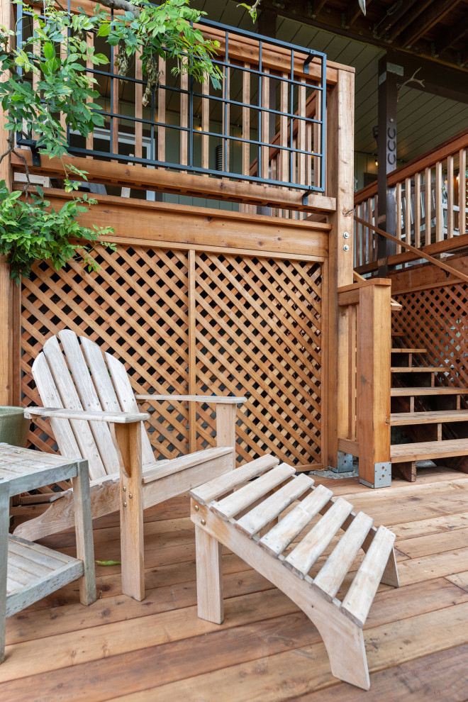 Large mountain style backyard ground level wood railing deck photo in San Francisco with no cover