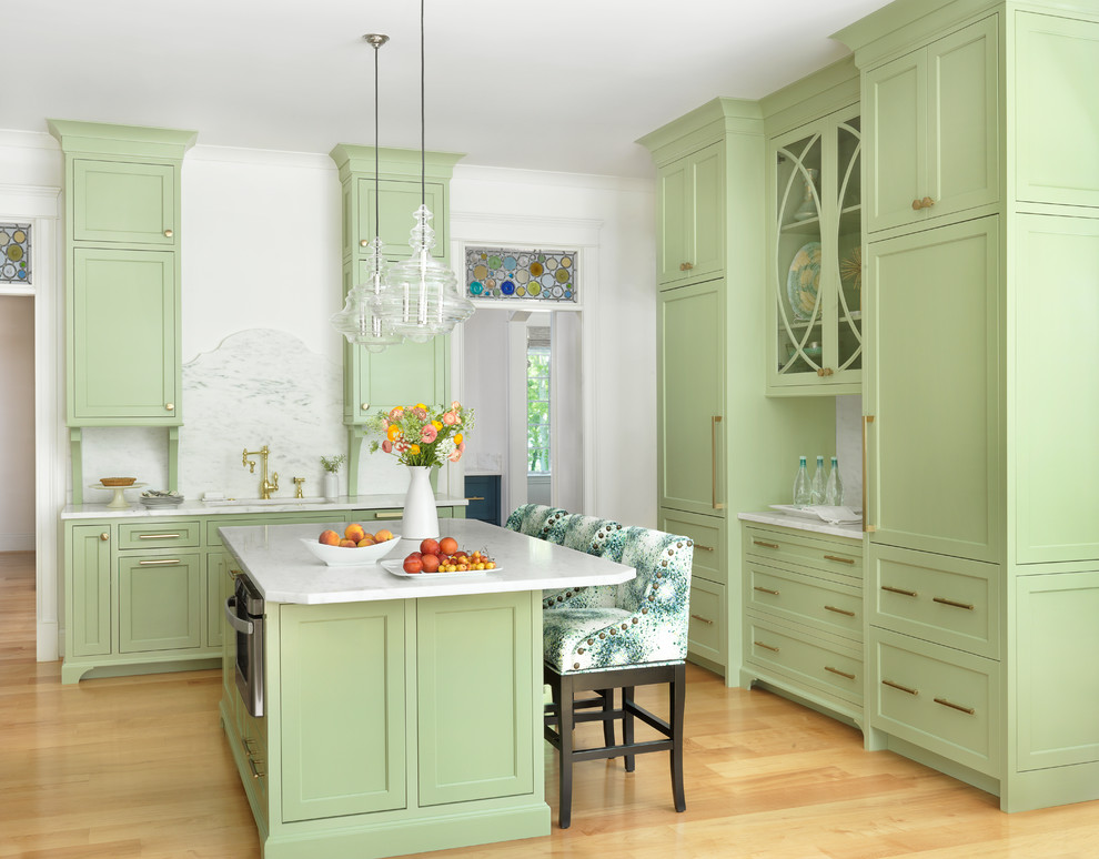 Design ideas for a large transitional kitchen in St Louis with an undermount sink, shaker cabinets, green cabinets, marble benchtops, white splashback, marble splashback, light hardwood floors, with island and beige floor.