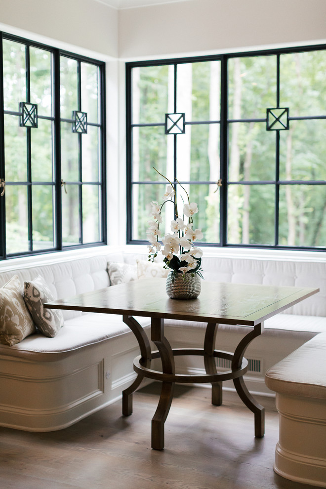 Example of a mid-sized transitional l-shaped brown floor and medium tone wood floor enclosed dining room design in Atlanta with shaker cabinets, white cabinets, wood countertops, white backsplash, stainless steel appliances, no island, white walls and no fireplace