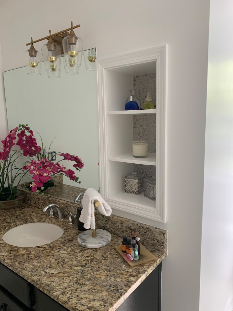 Mid-sized eclectic kids' multicolored tile and ceramic tile ceramic tile, brown floor and single-sink bathroom photo in Atlanta with raised-panel cabinets, a one-piece toilet, white walls, an undermount sink, granite countertops, multicolored countertops and a freestanding vanity