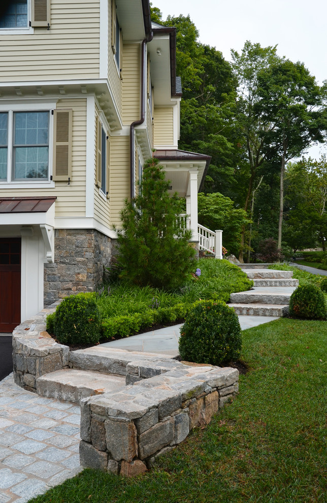 Traditional two-storey beige exterior in New York with wood siding.