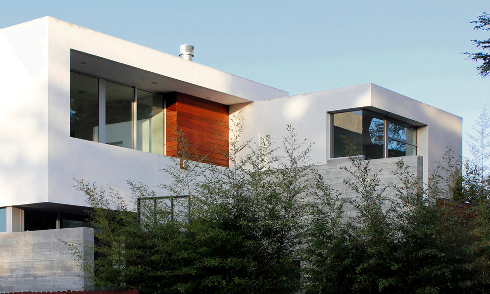 Inspiration for a large modern three-storey white house exterior in Los Angeles with wood siding and a flat roof.