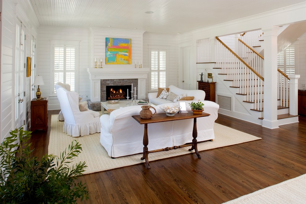 Inspiration for a large beach style open concept living room in Charleston with medium hardwood floors, white walls, a standard fireplace and a stone fireplace surround.