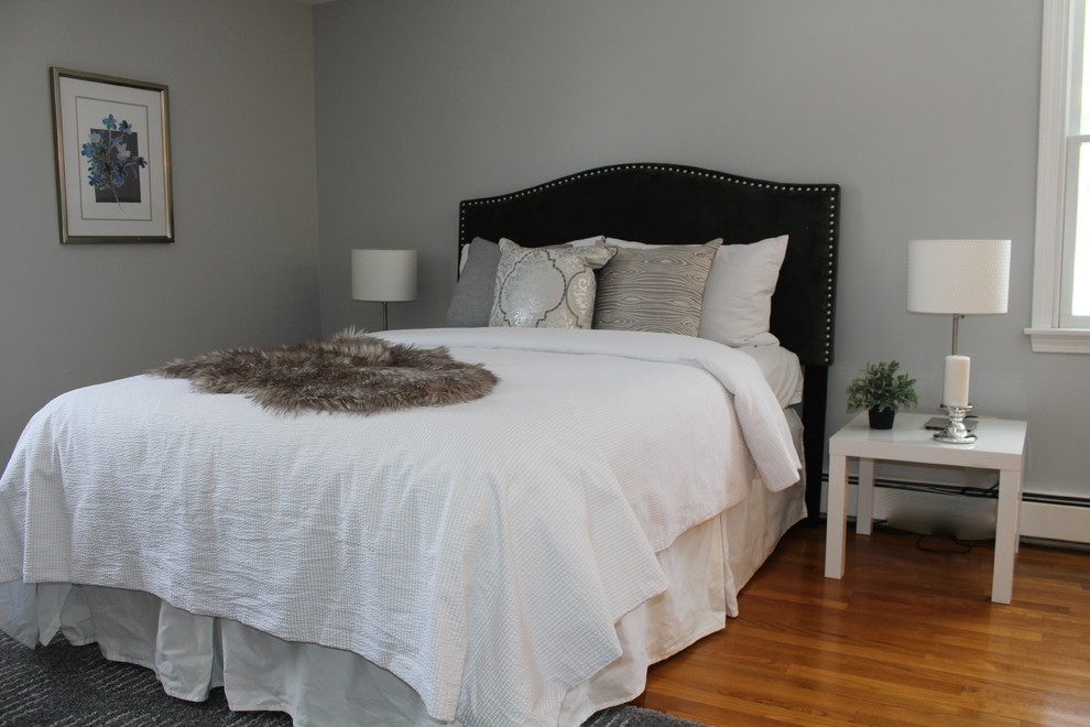 Mid-sized transitional master bedroom in Boston with grey walls and medium hardwood floors.