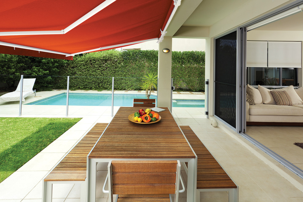 Inspiration for a contemporary backyard patio in Portland Maine with an awning.