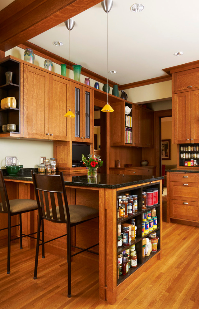 Photo of an arts and crafts kitchen in Minneapolis with shaker cabinets and medium wood cabinets.