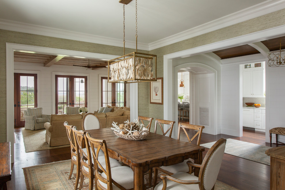 Photo of a beach style dining room in Charleston with green walls, medium hardwood floors, no fireplace and brown floor.