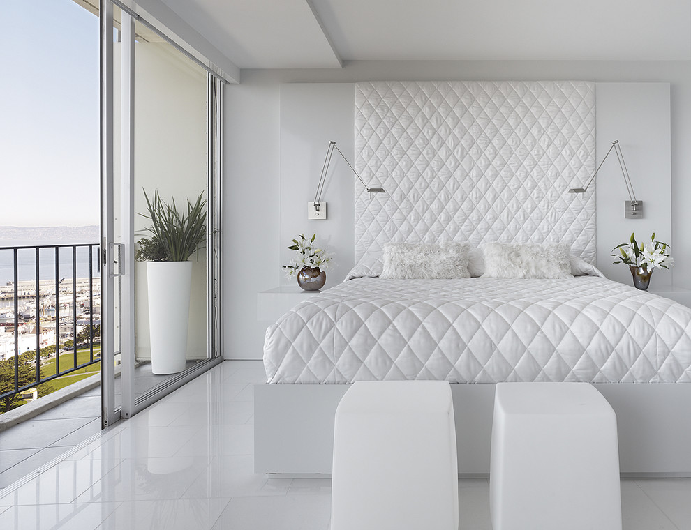 This is an example of a modern bedroom in San Francisco with white walls, marble floors and white floor.