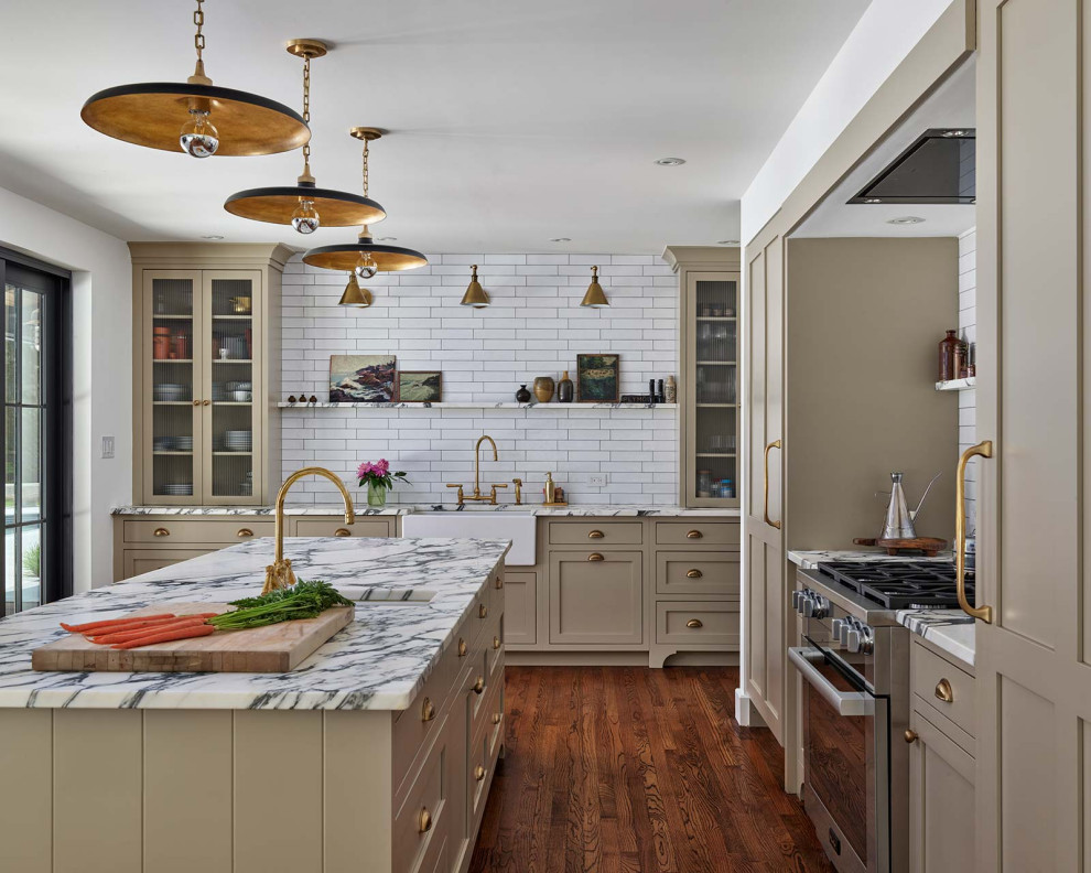 Large cottage l-shaped brown floor and medium tone wood floor eat-in kitchen photo in Philadelphia with marble countertops, stainless steel appliances, an island, white countertops, a farmhouse sink, shaker cabinets, beige cabinets, yellow backsplash and subway tile backsplash