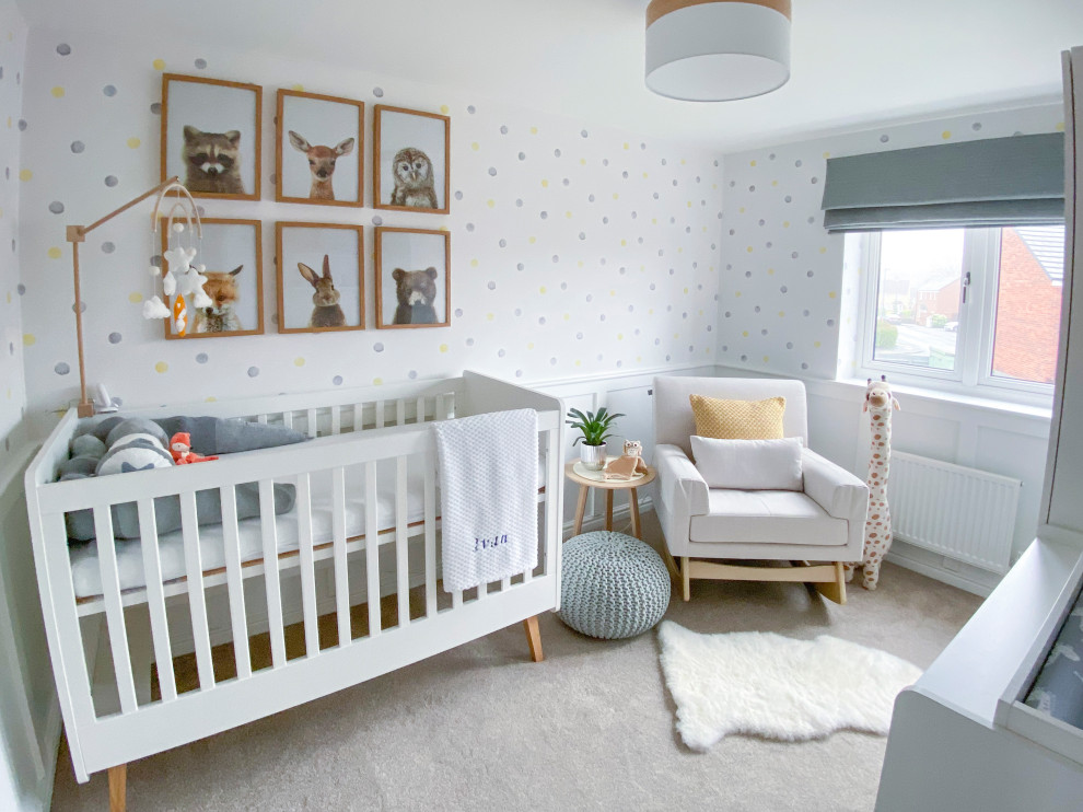 Design ideas for a medium sized modern nursery for boys in Other with white walls, carpet, beige floors and panelled walls.