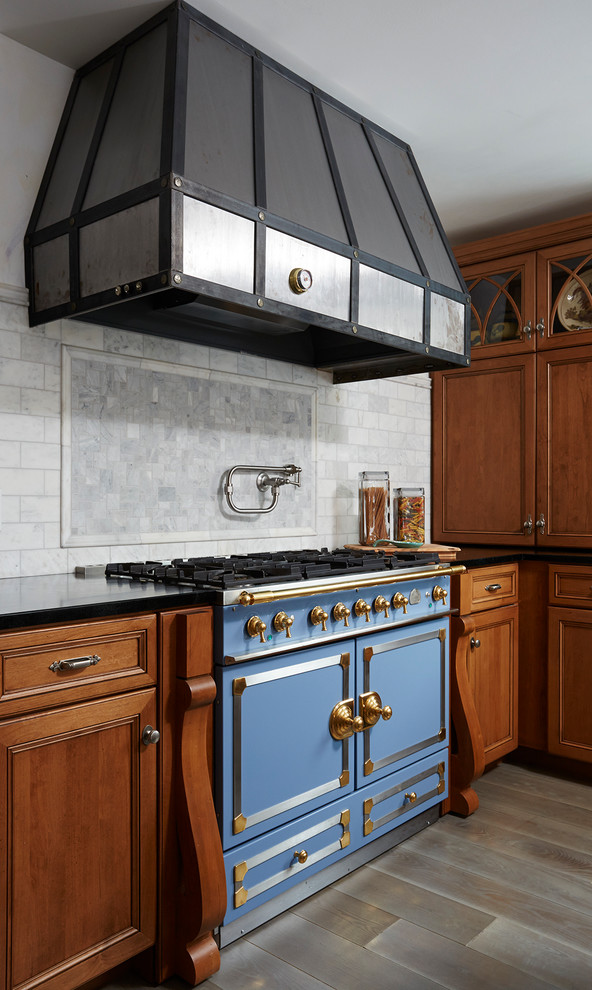 Inspiration for a large traditional u-shaped eat-in kitchen in Minneapolis with flat-panel cabinets, medium wood cabinets, marble benchtops, white splashback, stone tile splashback, panelled appliances, medium hardwood floors and with island.