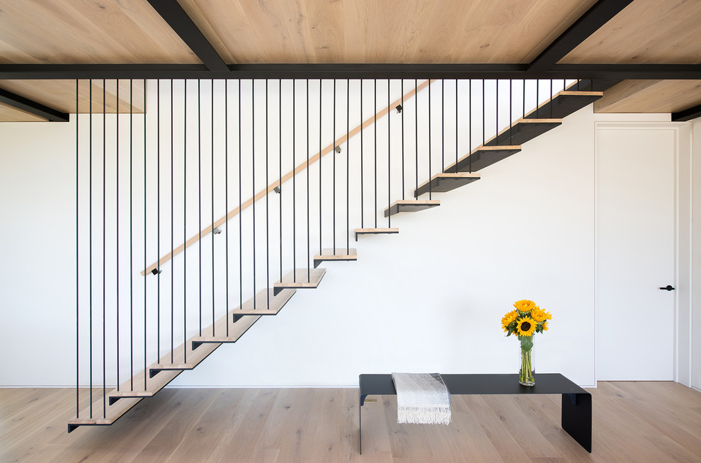 Modern wood floating staircase in New York with open risers.