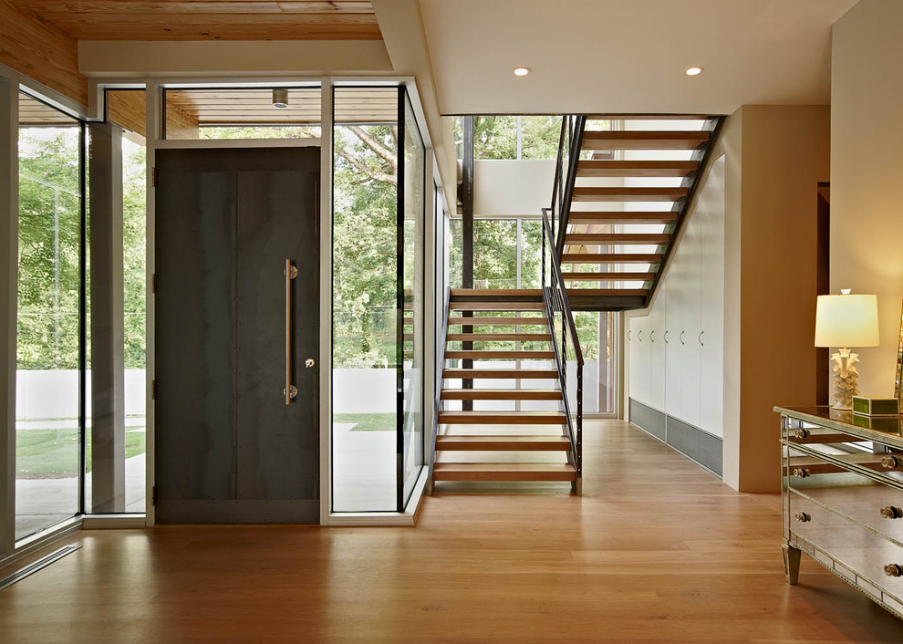 This is an example of a modern foyer in Charlotte with a single front door and a black front door.