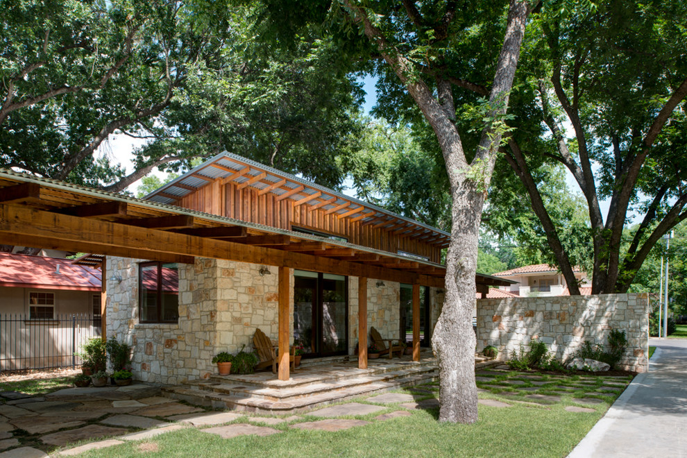 Inspiration for a contemporary patio in Austin with a roof extension.