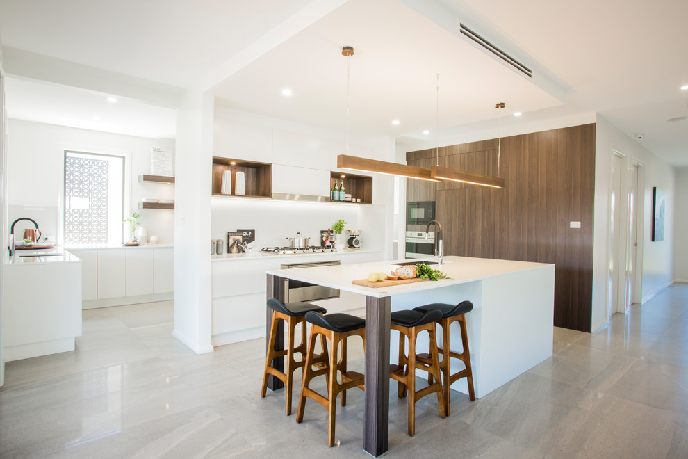 Inspiration for a large contemporary galley open plan kitchen in Sydney with a drop-in sink, louvered cabinets, dark wood cabinets, quartz benchtops, white splashback, glass sheet splashback, stainless steel appliances, ceramic floors and with island.